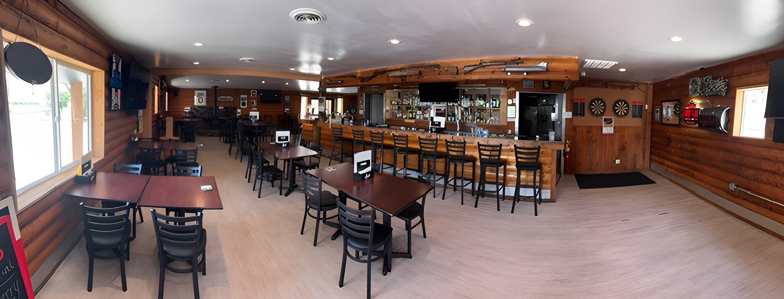 Tables, bar stools and bar at The Iconic Stoddard Road House Bar